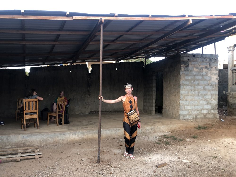 Cathy Monnet and the roof she and her organisation funded; with Regine Haguet and Thomas Vahle in the background.  Photo by Sylvain Leroux