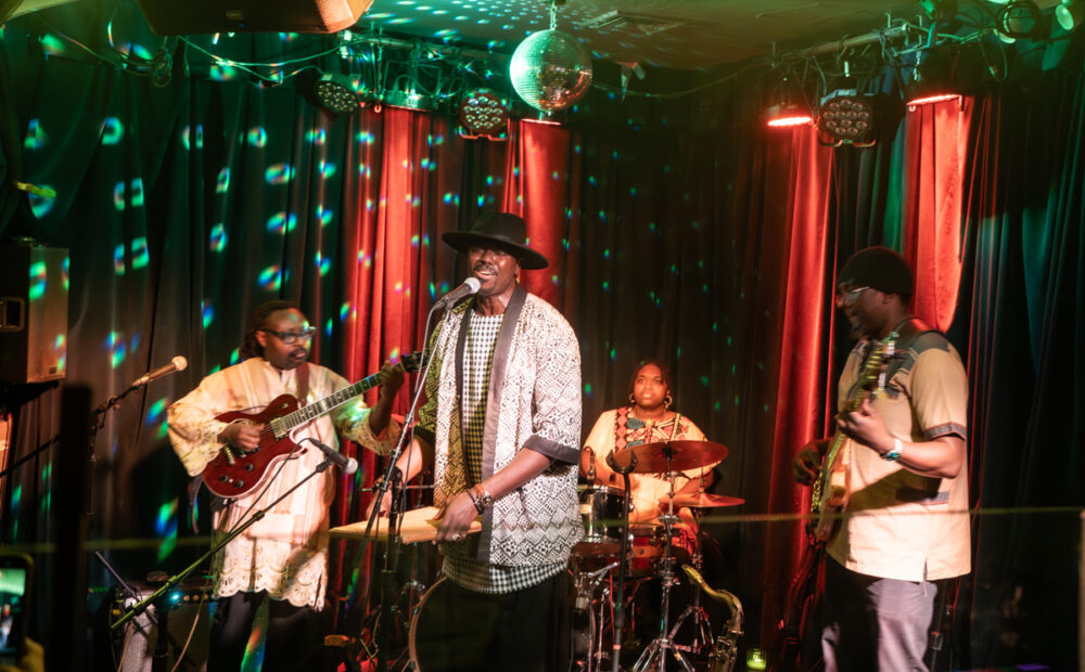 Cheikh with U.S. band at Berlin, NYC, 2026. Note his kayamba shaker!