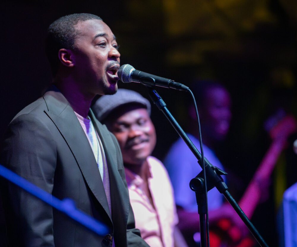 Papino Kouyate, lead singer for the band, and behind him, Jean, sitting in for Korka Dieng, the usual number two vocalist